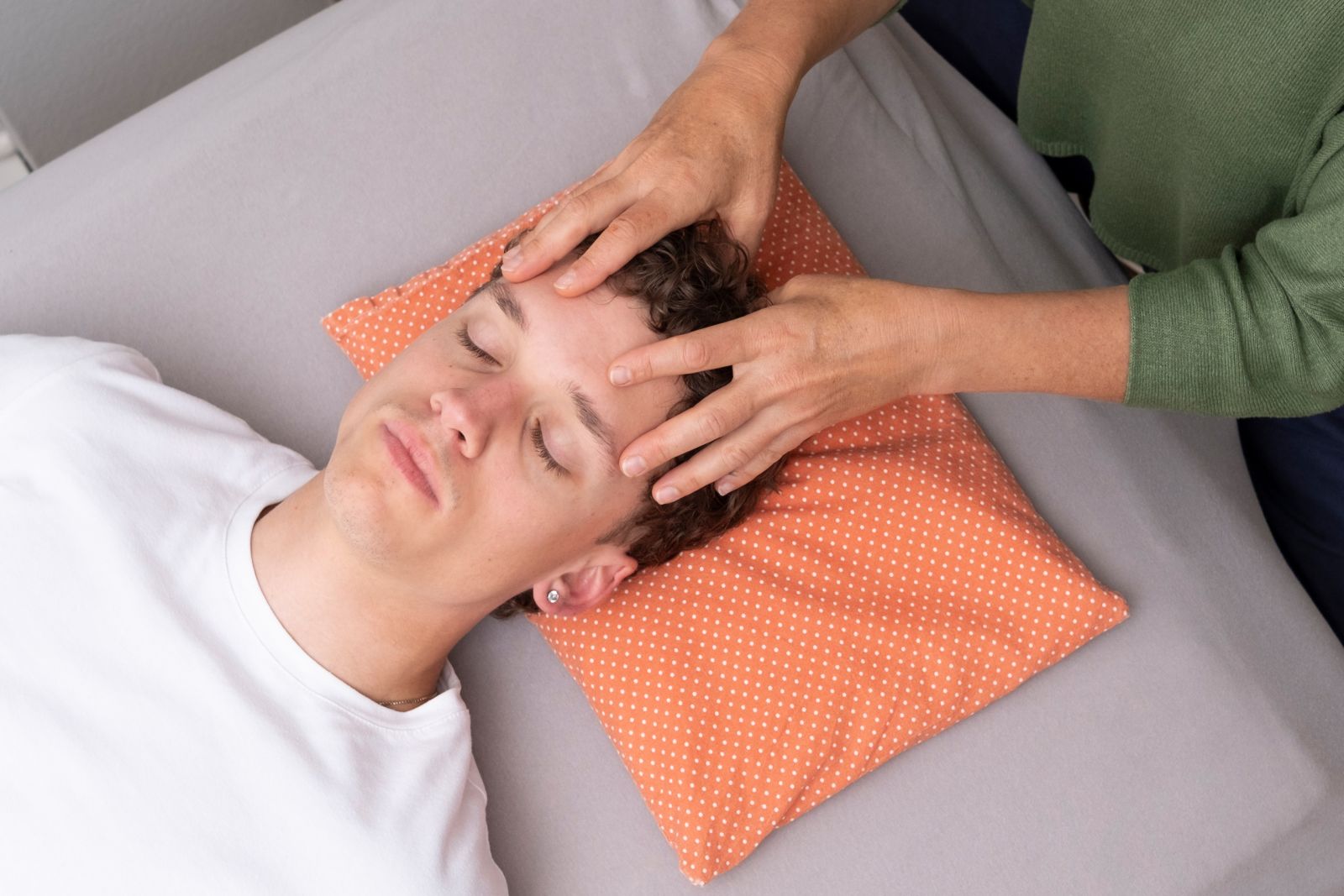 Therapeutin behandelt liegendem Jungen